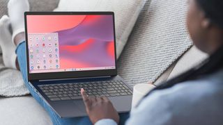 Woman sitting on couch with Lenovo 3i Chromebook on lap