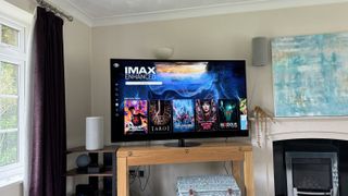 A photo of a TV on a wooden stand in a living room. On the screen is the IMAX Enhanced section of the Sony Pictures Core streaming service.