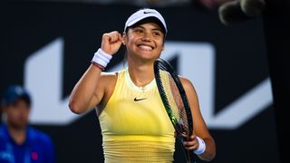 Emma Raducanu, wearing a yellow Nike tennis dress and white visor, pumps her fist prior to the Australian Open 2024 Raducanu vs Wang live stream 