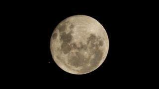 The moon and Mars (tiny orange dot) appear side by side in the sky before an occultation 