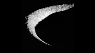 a light grey crescent shape against a totally black background