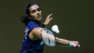 usarla V. Sindhu of India plays a shot, ahead of the 2024 Olympic Badminton, wearing a dark blue t-shirt.