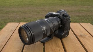 A Nikon Z telephoto lens on a wooden table