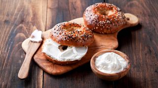 Cream cheese spread on a bagel next to a knife