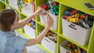 Applying labels to toy boxes to organize