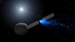 spacecraft with two long solar panels and a glowing blue exhaust approaches a small rocky world - Ceres.