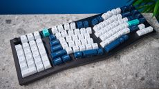 A black Keychron Q14 Max Alice keyboard with white, blue and teal keycaps