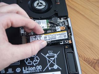 Pull the SSD away from the slot