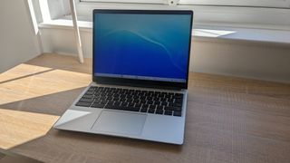 The Framework Laptop Chromebook Edition photographed on a wooden desk.