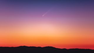 a comet soars through the sky with a long white tail. the early morning sky is awash with color, with vivid hues of orange, red and purple.