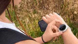 Woman checking stats on Garmin Lily