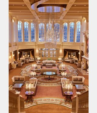 high-ceilinged entrance lobby with seating and chandelier