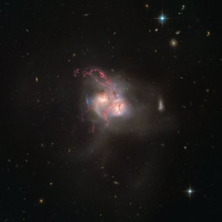 This spectacular Hubble Space Telescope view of the cosmic object NGC 5256 shows what happens when galaxies collide. The image, released Dec. 14, catches two galaxies colliding 350 million light-years away from Earth.