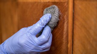 Rubbing wood with steel wool