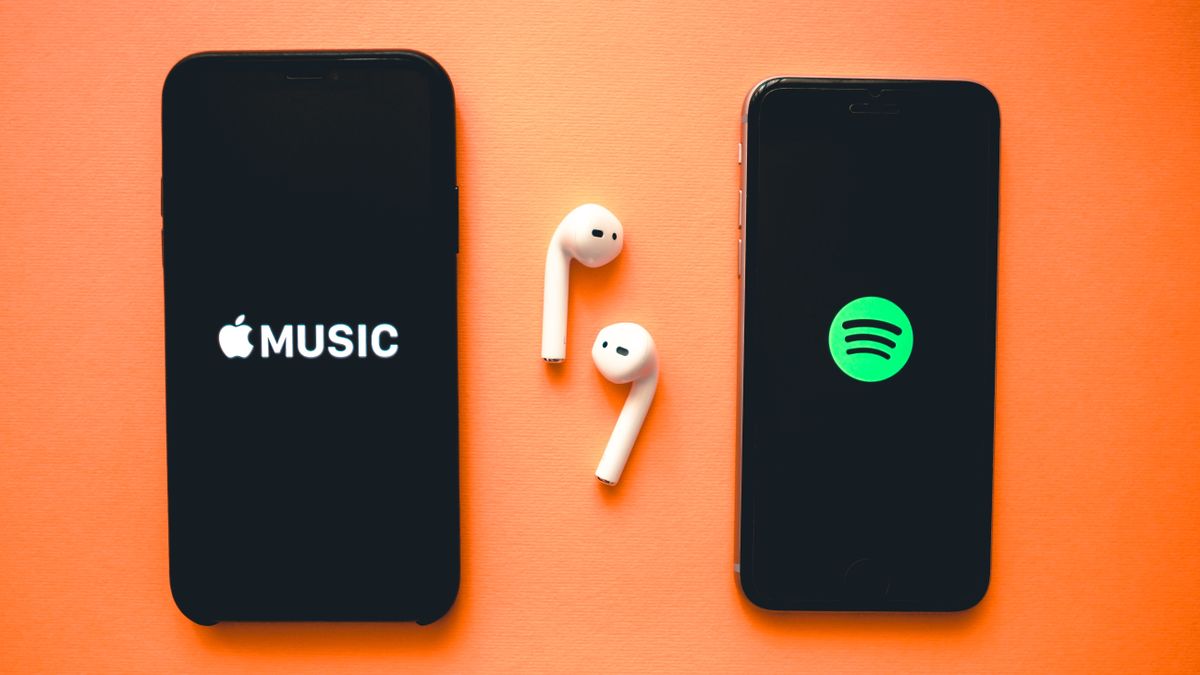 Apple Music and Spotify logos on phones with AirPods between them