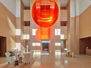 the jeddah edition grand lobby with orange chandelier