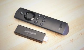 The Amazon Fire TV stick and its remote on a table