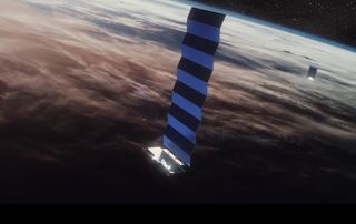 An artist's illustration of SpaceX's Starlink internet satellites in orbit.