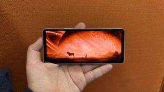 Sony Xperia 10 VI in hand with a scene from Rebel Moon on Netflix on screen