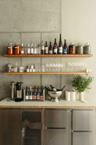 Close up shot of bar with wine bottles, glasses & fridges