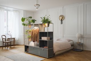 Bedroom with shelving at foot of bed