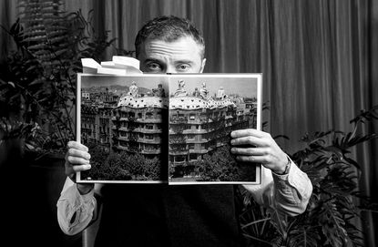 Thomas Heatherwick holding out book on spread with gaudi work as a spread from &#039;humanise&#039;