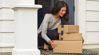 Amazon boxes being picked up at the front door.