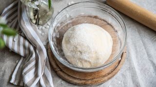 Bread dough in clear bowl waiting to rise