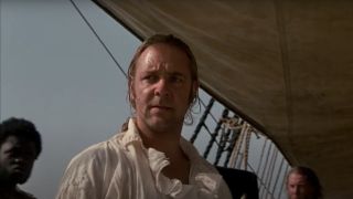 Russell Crowe stands looking stern in the sunlight on deck in Master and Commander: Far Side of the World.