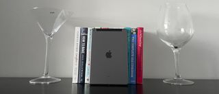 The Apple iPad 10.2 (2021) resting against some books