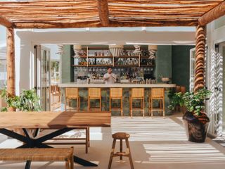 Hyde Ibiza Bungalow bar area with wooden chairs and tables