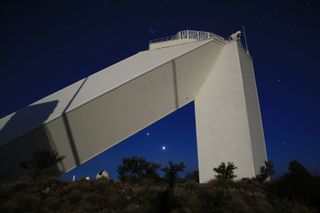 a large structure against a starry background with two particularly bright points of light - venus and jupiter.