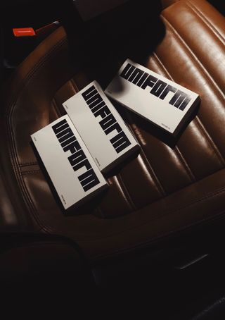 boxes of uniform fragrance on brown leather car seat