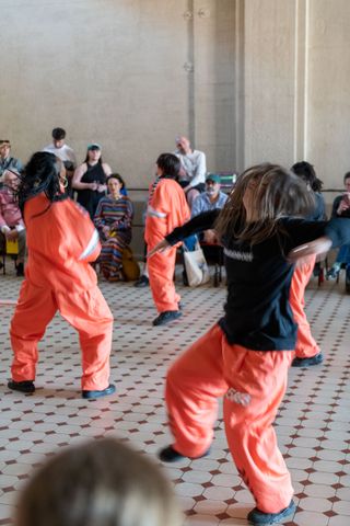 people in bright clothes in art performance at E-WERK Luckenwalde