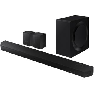 A black Samsung Q990D soundbar, subwoofer and two speakers on a white background.