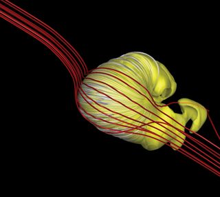 An updated model suggests the shape of the sun’s bubble of influence, the heliosphere (seen in yellow), may be a deflated croissant shape, rather than the long-tailed comet shape suggested by other research.