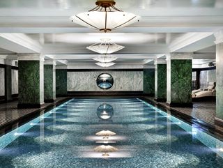 The Ned London spa pool with blue tiles and marble pillars