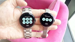 Google Pixel Watch 3 and Pixel Watch 3 XL in a user's hand against a pink background