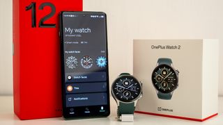 The OnePlus Watch 2 with a OnePlus 12 phone and their respective boxes