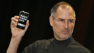 Steve Jobs holds up an original iPhone at 2007 Macworld Expo