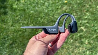 Shokz OpenRun Pro 2 headphones in a person's hand