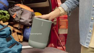 The Sonos Move 2 in the back of a car near some backpacks.