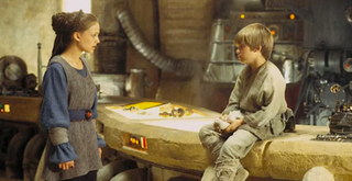 a woman talks to a little boy sitting on a counter