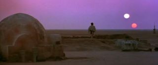 Film still from 'Star Wars Episode IV: A New Hope' showing the sunset on the planet Tatooine.