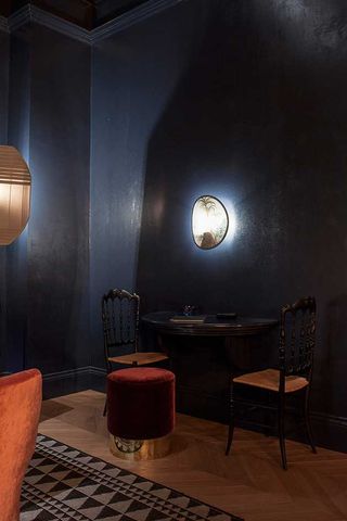 Old fashioned table and chairs lit by overhead light fixture