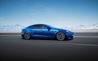 tesla model s plaid in blue in front of mountains