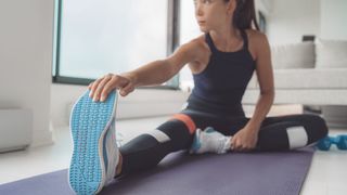 a photo of a woman doing a hamstring stretch