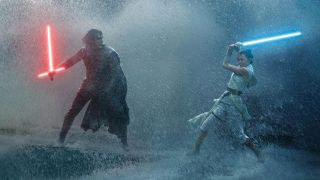 Still from the movie Star Wars: The Rise of Skywalker. Here we see Kylo Ren and Rey fighting intensely. Kylo Ren is wearing black and has a red broadsword-style lightsaber. Rey is wearing white and is holding a blue lightsaber. There is an epic storm raging on whilst they right.