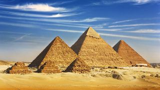 View from the Giza Plateau of the three pyramids known as Queens' Pyramids with three smaller three satellite pyramids in front. In order from left to right: the Pyramid of Menkaure, Khafre and then Khufu.