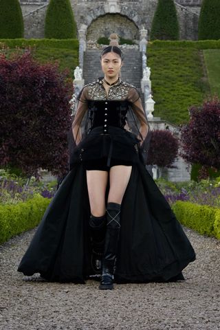 Dior runway show featuring model in black outfit